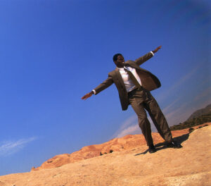 Businessman Balancing on a Rocky Slope - Johaloha